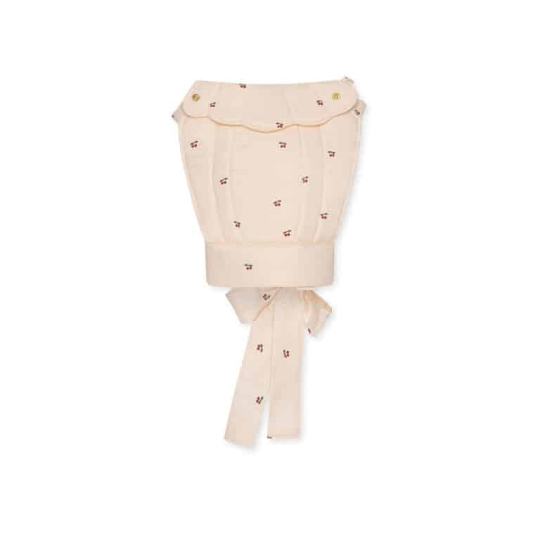 Un porte poupée avec des motifs cerises de la marque konges