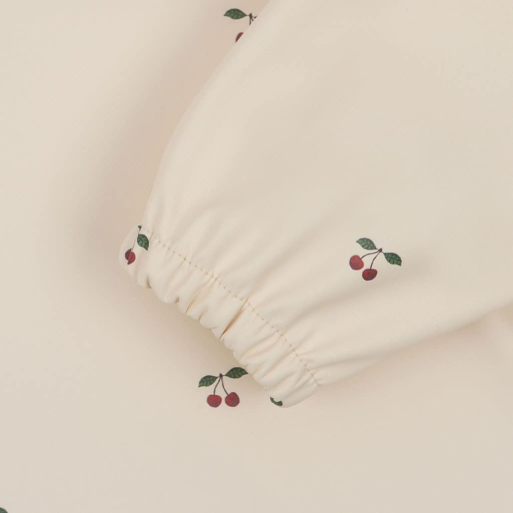 détail manche bavoir cerise konges