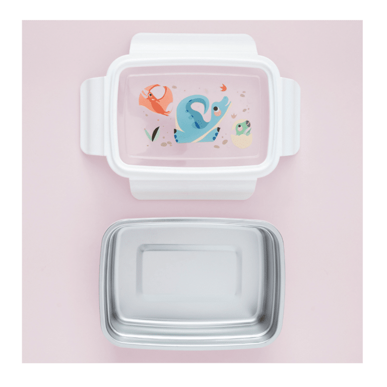 une boîte à repas transparente dinosaures avec un couvercle transparent et le récipient en acier peut se retirer. Vue de face avec les différents contenant sur fond rose