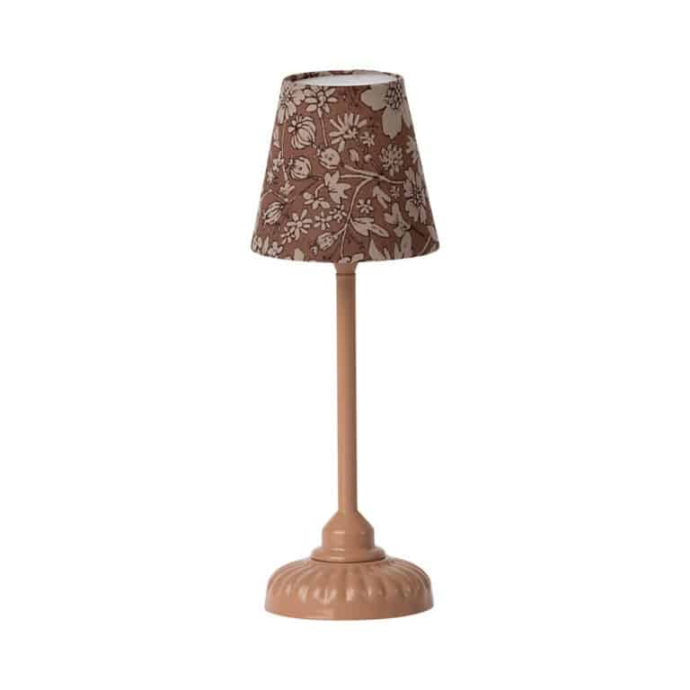 Une mini lampe vieux rose sur pied, vue de face sur fond blanc