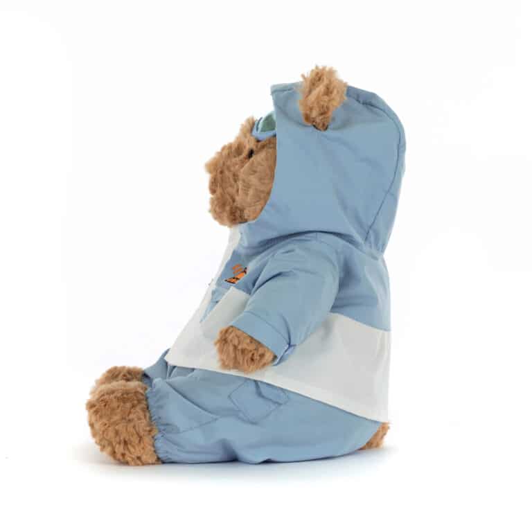 Doudou Ours Bartholomew en combinaison de neige bleue – Jellycat - Vu de côté sur fond blanc
