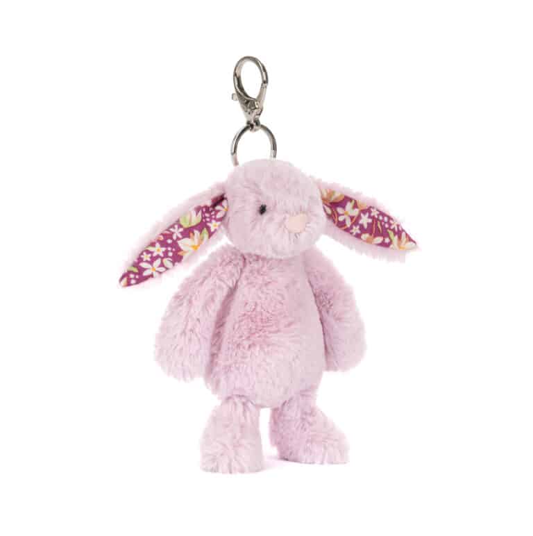 Thistlepop Blossom bunny bag charm - Jellycat, vue de biais sur fond blanc